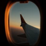 a view of the wing of an airplane through a window